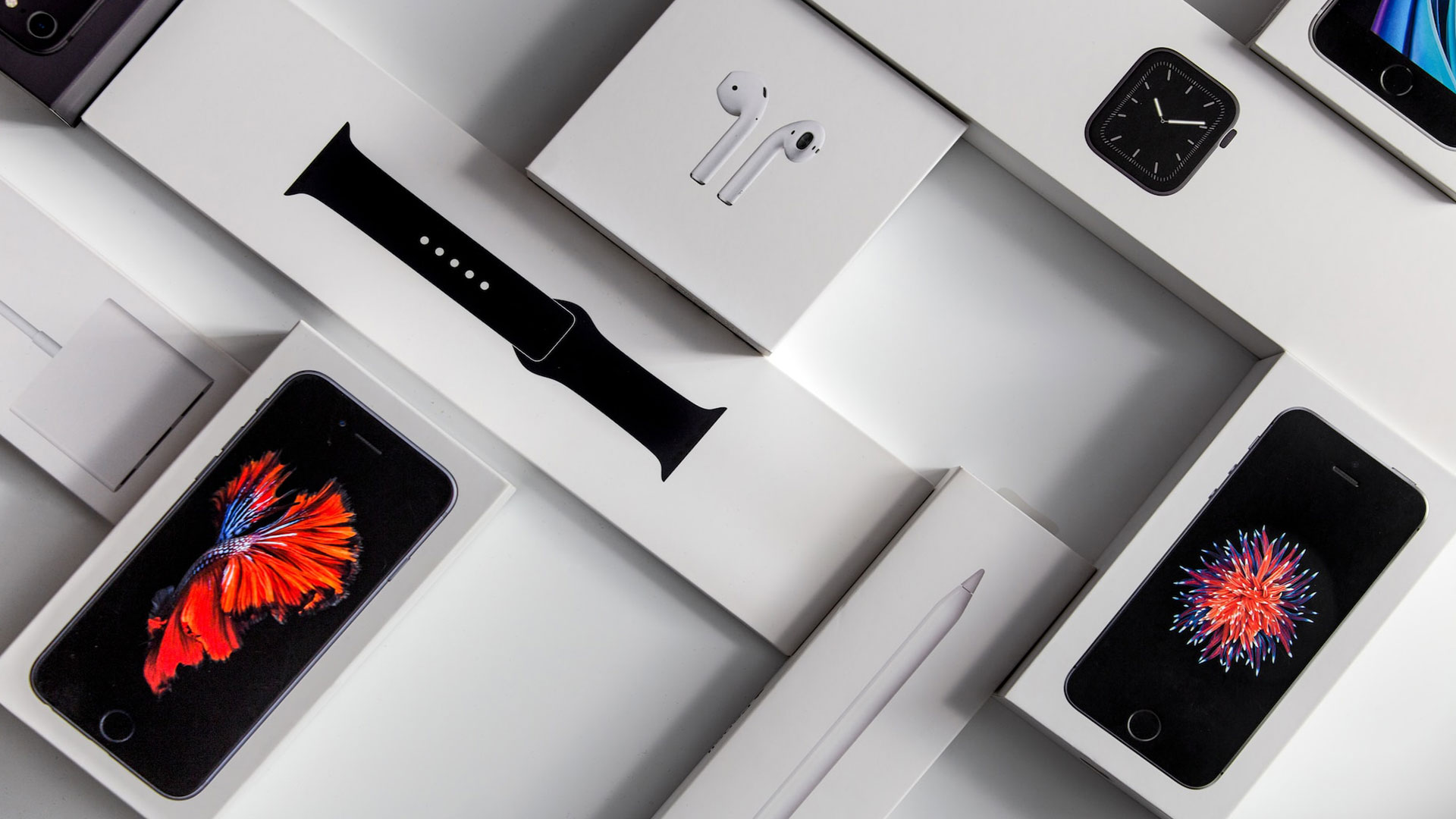 Packaging of various products including a smartphone, watch, electronic pencil, and charger.