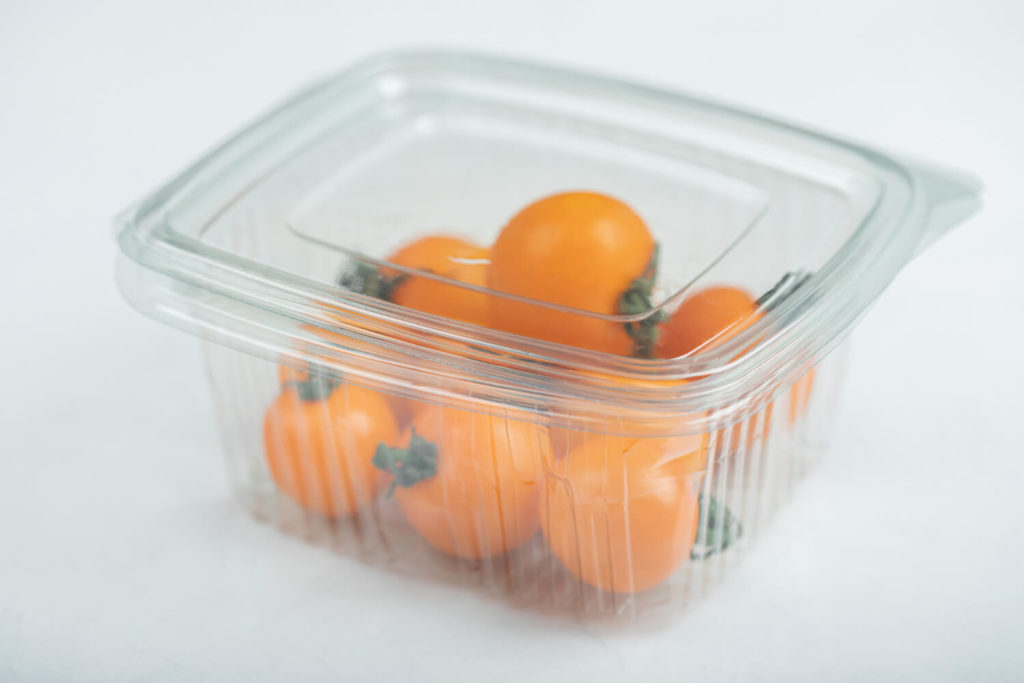 yellow cherry tomatoes in the plastic container or clamshell packaging